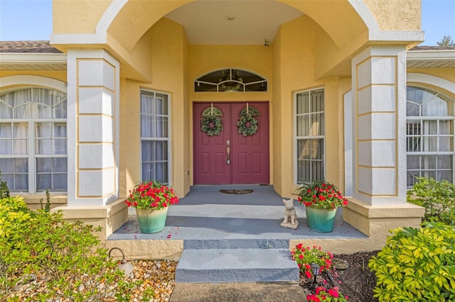 entrance to property featuring stucco siding