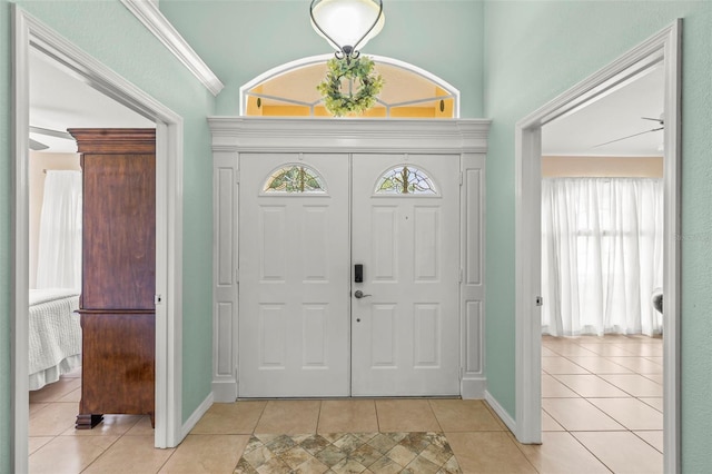entryway featuring light tile patterned floors and baseboards