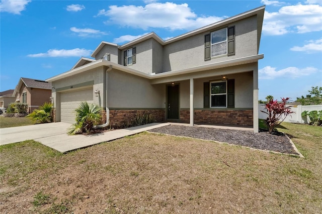 view of front of home featuring an attached garage, driveway, stucco siding, and a front lawn