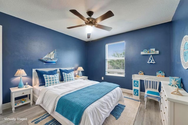 bedroom featuring light wood-style flooring, ceiling fan, and baseboards