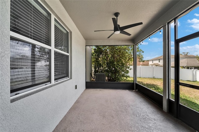 unfurnished sunroom with plenty of natural light and a ceiling fan