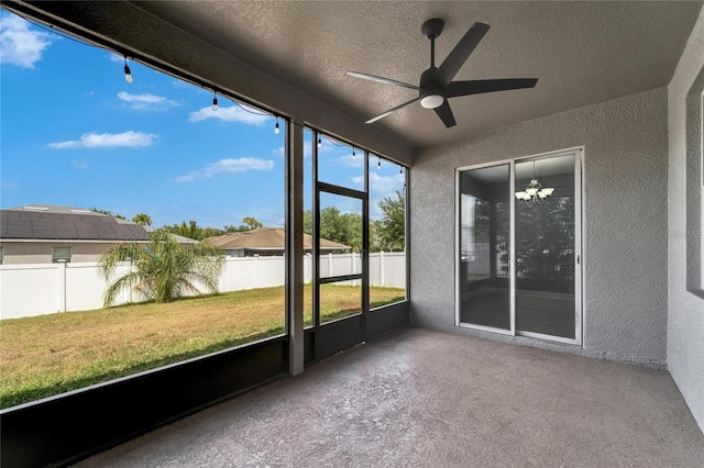 unfurnished sunroom featuring ceiling fan