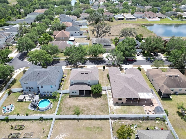drone / aerial view featuring a water view and a residential view