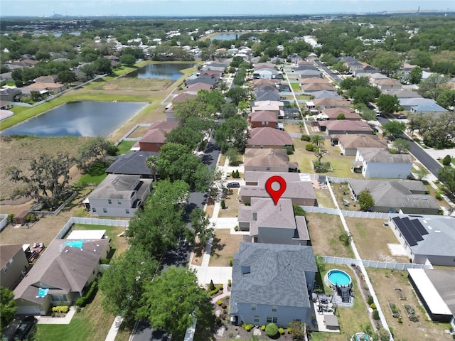 bird's eye view featuring a water view and a residential view