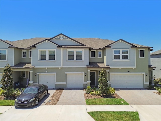 8953 Gallantree Pl, Land O Lakes, FL 34637 - view of front facade with a garage, driveway, and stucco siding