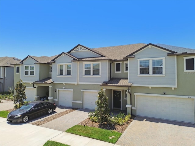 8953 Gallantree Pl, Land O Lakes, FL 34637 - view of front of property with an attached garage, driveway, and stucco siding