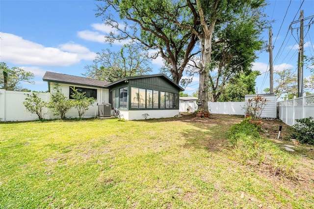 8115 N Ola Ave, Tampa, FL 33604 - back of house with an outbuilding, central air condition unit, a sunroom, a fenced backyard, and a lawn