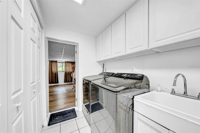 8115 N Ola Ave, Tampa, FL 33604 - laundry room with light tile patterned floors, washing machine and dryer, a sink, and cabinet space