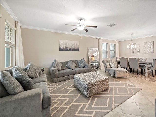 living room with tile patterned flooring, visible vents, ornamental molding, and ceiling fan with notable chandelier