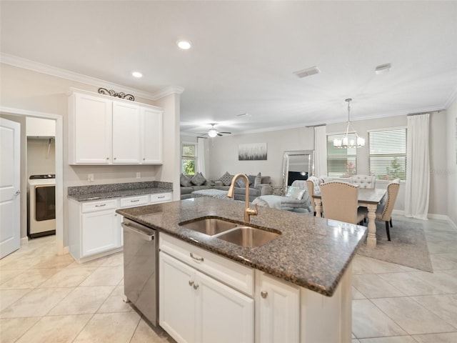 kitchen with stainless steel dishwasher, crown molding, washer / dryer, open floor plan, and a sink