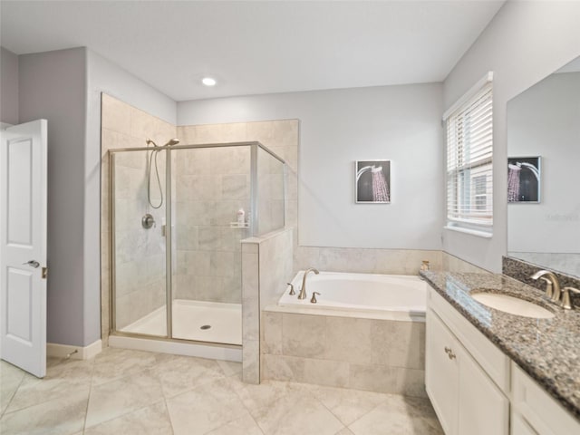 bathroom featuring a garden tub, vanity, tile patterned flooring, and a shower stall