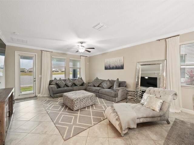 living area with crown molding, a ceiling fan, light tile patterned flooring, and visible vents
