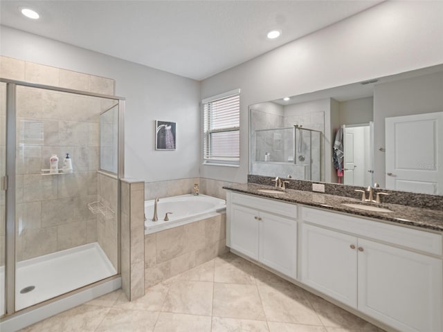 bathroom featuring double vanity, a sink, a bath, and a shower stall