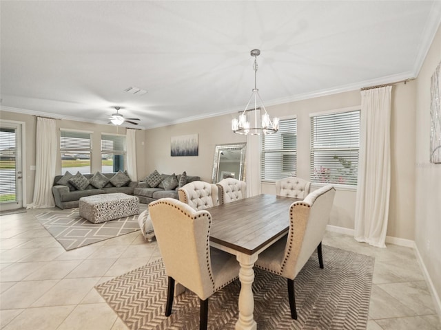 dining room with light tile patterned floors, crown molding, and a wealth of natural light