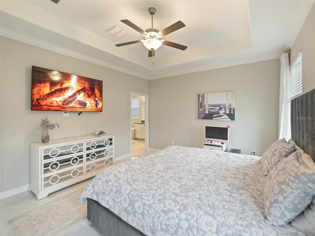 bedroom with a tray ceiling, baseboards, and marble finish floor