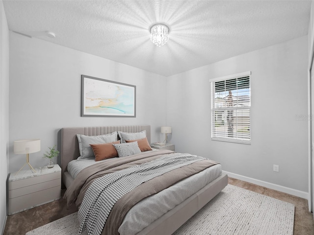 bedroom with a textured ceiling and baseboards