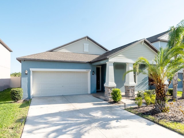 view of front facade featuring a garage, stucco siding, driveway, and a shingled roof