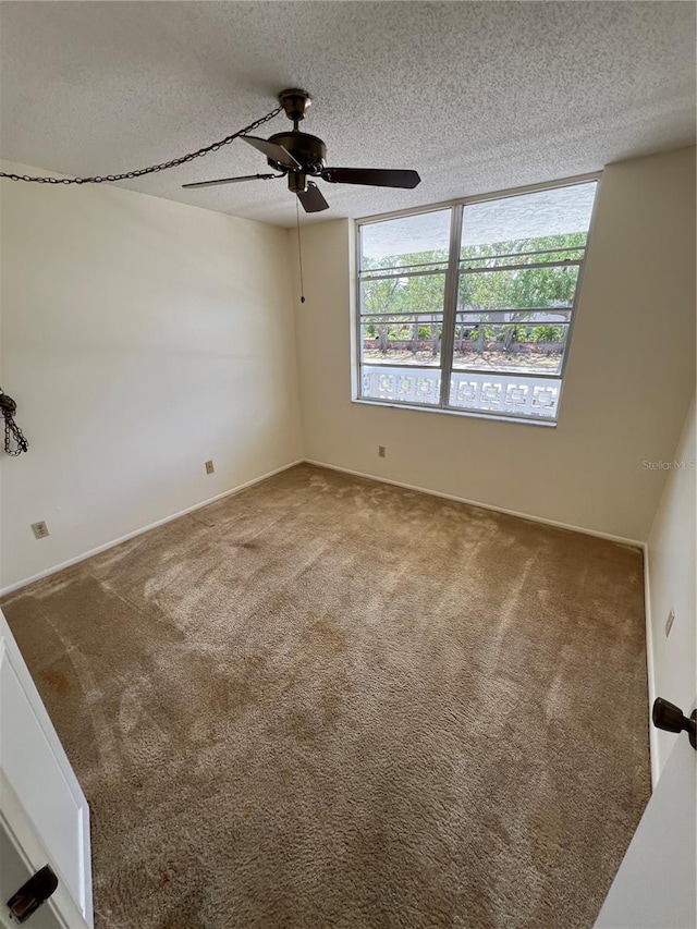 4715 Bay St NE Unit 235, Saint Petersburg, FL 33703 - spare room with ceiling fan, carpet flooring, and a textured ceiling