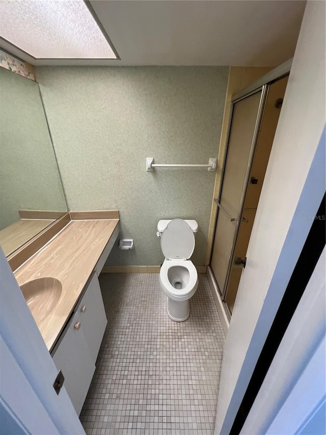 4715 Bay St NE Unit 235, Saint Petersburg, FL 33703 - full bathroom featuring a shower stall, tile patterned floors, vanity, and toilet