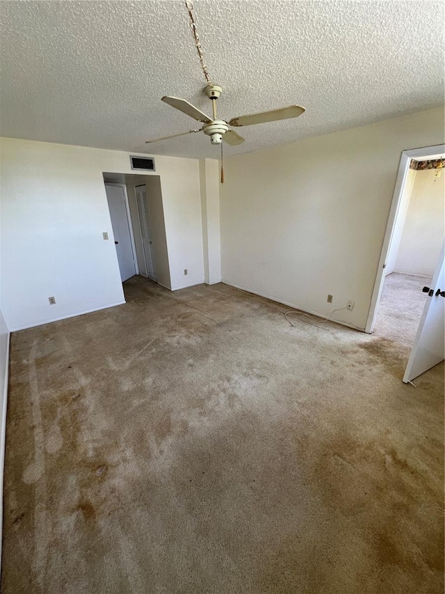 4715 Bay St NE Unit 235, Saint Petersburg, FL 33703 - unfurnished bedroom featuring a textured ceiling, ceiling fan, visible vents, and carpet floors
