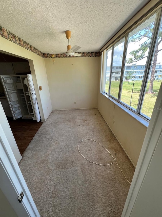 4715 Bay St NE Unit 235, Saint Petersburg, FL 33703 - empty room with carpet, a textured ceiling, and ceiling fan