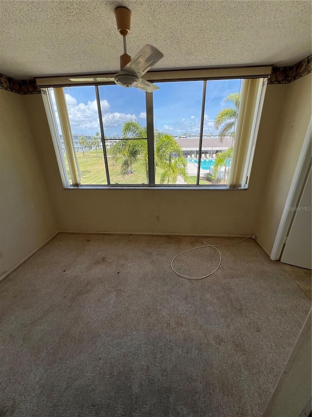 4715 Bay St NE Unit 235, Saint Petersburg, FL 33703 - spare room featuring ceiling fan, carpet flooring, and a textured ceiling