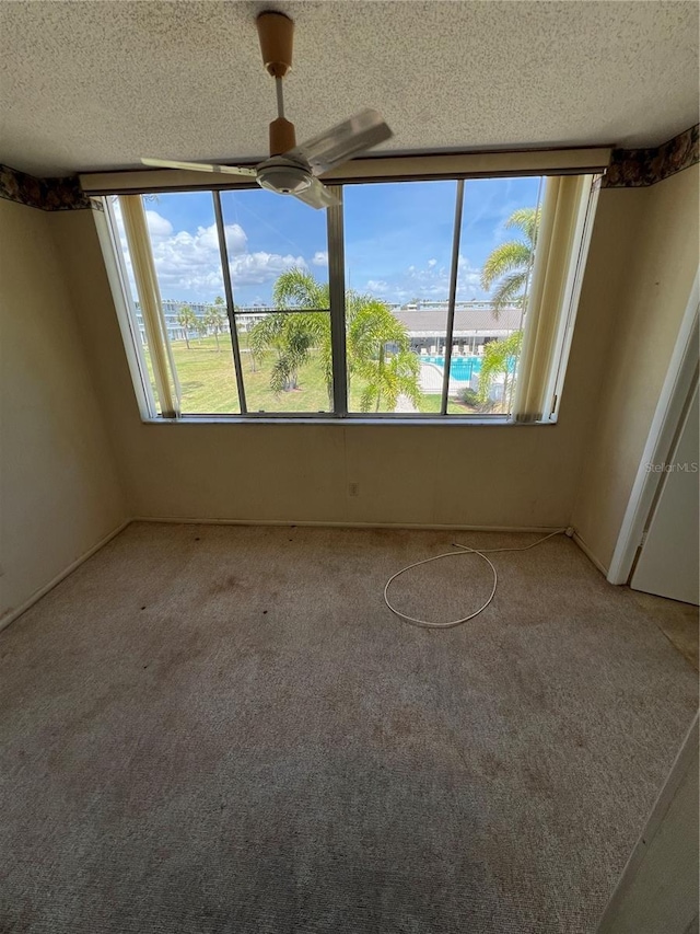 4715 Bay St NE Unit 235, Saint Petersburg, FL 33703 - carpeted empty room featuring a textured ceiling and ceiling fan