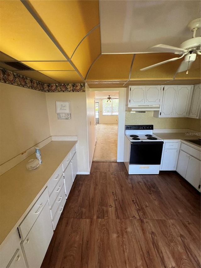 4715 Bay St NE Unit 235, Saint Petersburg, FL 33703 - kitchen featuring white cabinetry, a ceiling fan, under cabinet range hood, dark wood-type flooring, and range with electric cooktop