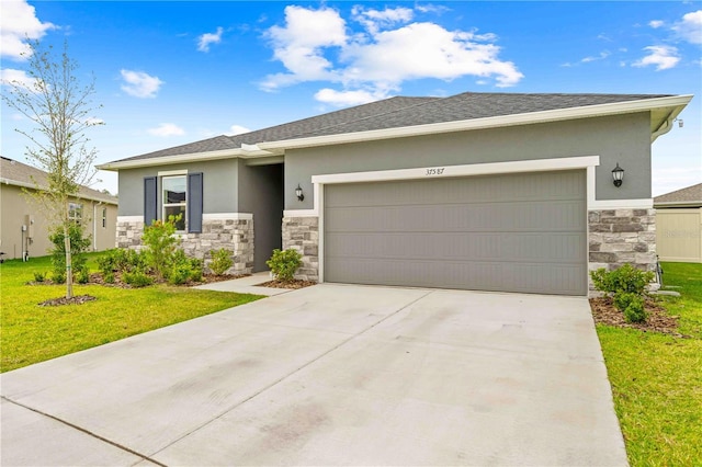 prairie-style home featuring stucco siding, stone siding, a front lawn, an attached garage, and concrete driveway