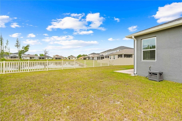 view of yard with a residential view and a fenced backyard
