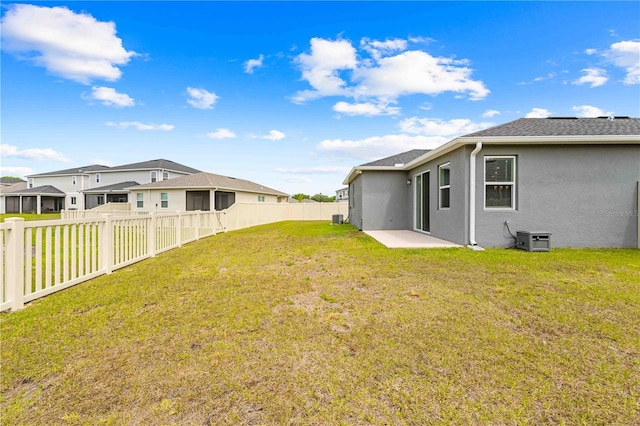 view of yard featuring a fenced backyard and a residential view