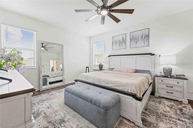 bedroom featuring baseboards, a ceiling fan, and wood finished floors