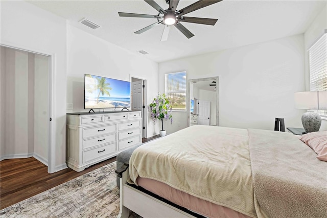 bedroom featuring a ceiling fan, dark wood finished floors, and visible vents