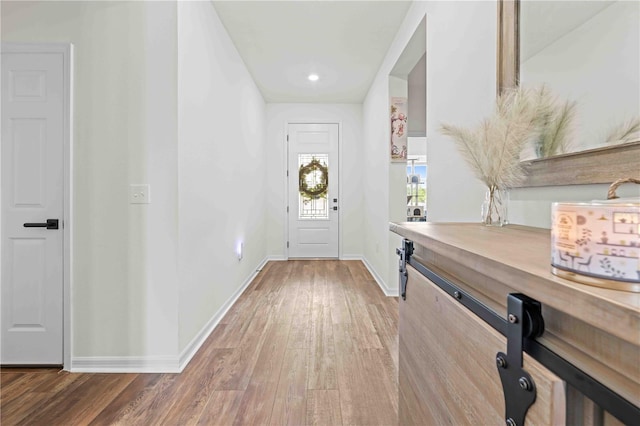 foyer featuring hardwood / wood-style flooring and baseboards