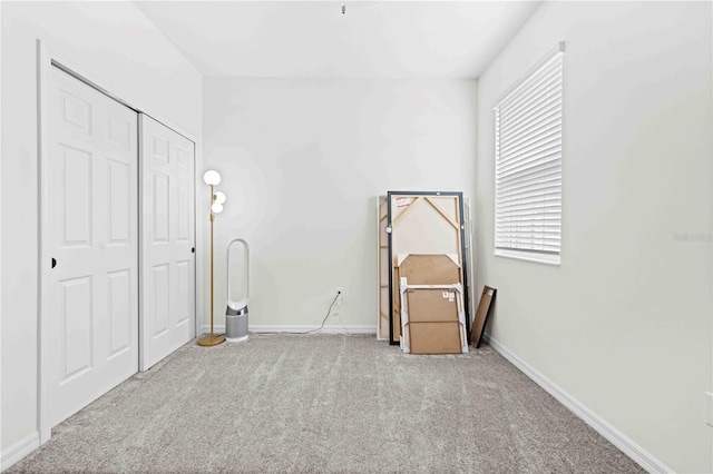 unfurnished bedroom with a closet, carpet flooring, and baseboards