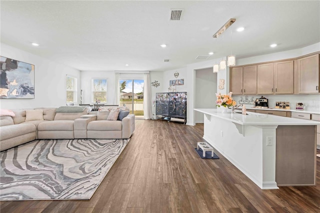 living area with recessed lighting, dark wood-type flooring, and visible vents
