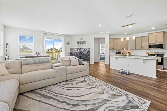 living room featuring visible vents, recessed lighting, and dark wood-style floors