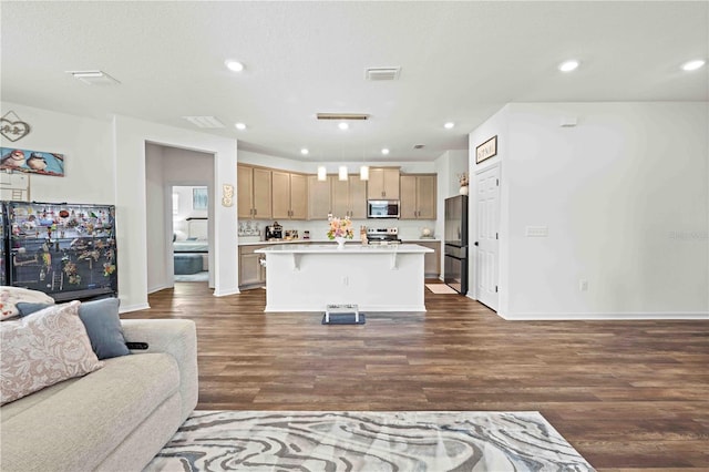 living room with recessed lighting, visible vents, baseboards, and dark wood finished floors