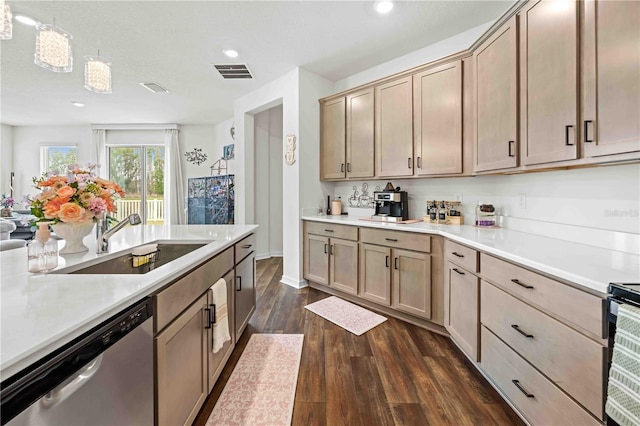 kitchen featuring stainless steel dishwasher, dark wood finished floors, visible vents, light countertops, and a sink