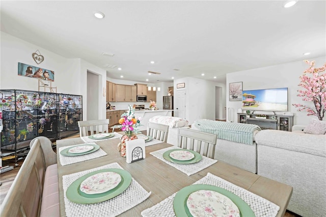 dining area featuring light wood finished floors and recessed lighting