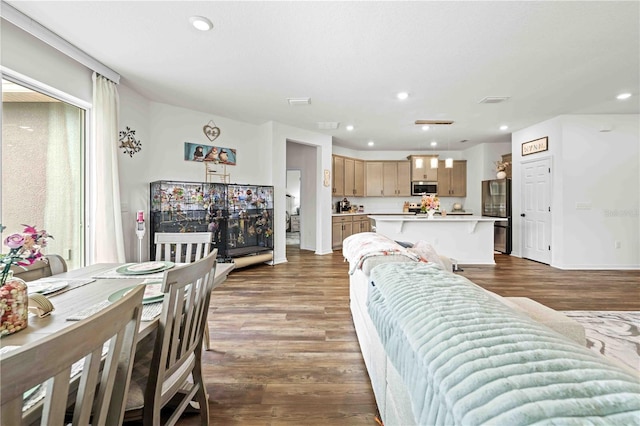 living area featuring recessed lighting, visible vents, and dark wood finished floors