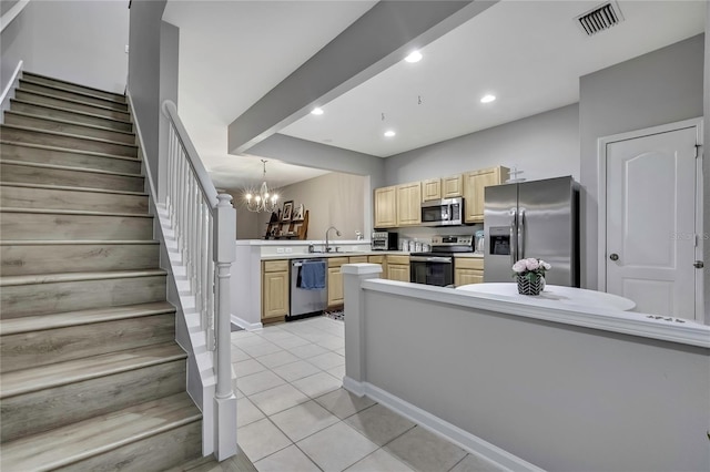 kitchen with light brown cabinets, light countertops, light tile patterned flooring, visible vents, and appliances with stainless steel finishes