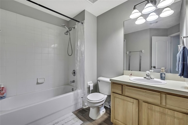 bathroom featuring vanity, shower / bath combo, toilet, visible vents, and wood finished floors