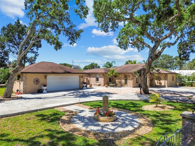 6732 Udell Ln, Hudson, FL 34667 - ranch-style home with curved driveway, a garage, a front yard, and brick siding