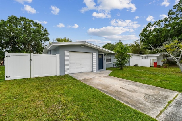 2401 Havana Dr, Clearwater, FL 33764 - ranch-style home with a front yard, an attached garage, a gate, and driveway