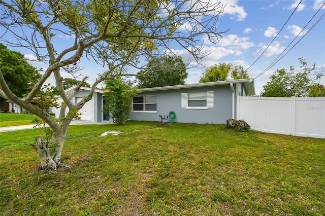2401 Havana Dr, Clearwater, FL 33764 - rear view of property with a garage, a yard, stucco siding, and fence