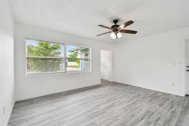 2401 Havana Dr, Clearwater, FL 33764 - empty room with a textured ceiling, wood finished floors, and ceiling fan