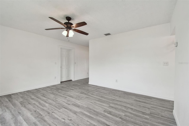 2401 Havana Dr, Clearwater, FL 33764 - spare room featuring visible vents, baseboards, a ceiling fan, and wood finished floors