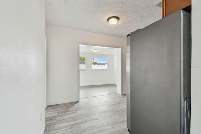 2401 Havana Dr, Clearwater, FL 33764 - hallway with baseboards, light wood-type flooring, and a textured ceiling