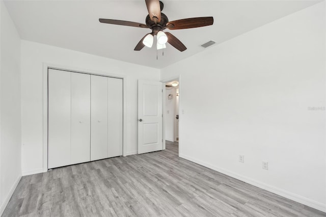 2401 Havana Dr, Clearwater, FL 33764 - unfurnished bedroom featuring a closet, baseboards, visible vents, ceiling fan, and wood finished floors